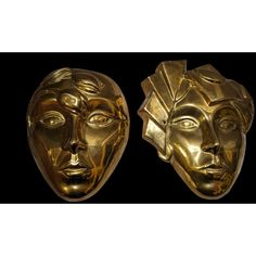 two golden masks are shown against a black background