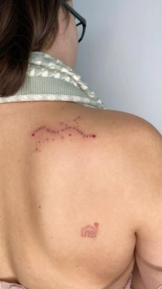 a woman with a small tattoo on her back