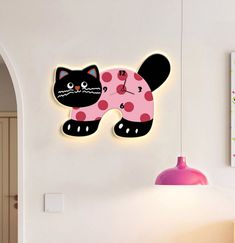 a clock with a black cat on it's face and pink polka dot dress