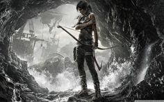 a woman with a bow and arrow standing in a cave