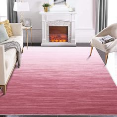 a living room with a fire place in the fireplace and pink rug on the floor