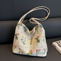 Meet your new sidekick for cafe-hopping, study marathons, and errand runs – our fab floral embroidered bag! With its charming blooms and roomy interior, it's like carrying a garden of style wherever you go. Plus, it's perfect for hiding that stash of emergency snacks – because who says fashion can't be functional?" Materials Canvas, Polyester, Magnetic buckle Spring Large Capacity Canvas Satchel, Spring Large Capacity Canvas Satchel Bag, Spring Large Capacity Satchel Canvas Bag, Spring Large Capacity Canvas Bag With Double Handle, Spring Tote Satchel For Daily Use, Spring Large Capacity Double Handle Canvas Bag, Spring Large Capacity Hobo Bag For Everyday, Large Capacity Spring Canvas Satchel Bag, Everyday Floral Print Double Handle Shoulder Bag