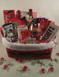 a christmas gift basket with wine, candy and candies