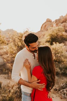 a man and woman embracing in the desert