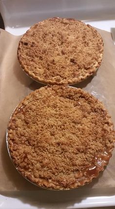 two pies sitting on top of a white tray