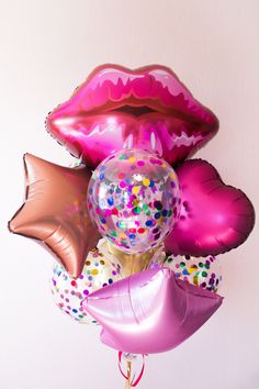 some balloons and confetti in the shape of lips