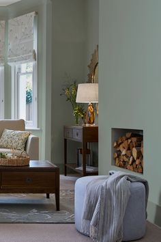 a living room filled with furniture and a fire place in front of a large window