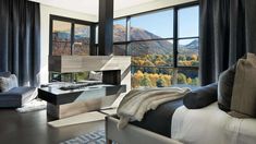 a bedroom with a large window overlooking the mountains