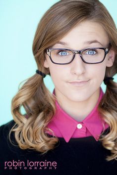 a woman wearing glasses and a pink shirt