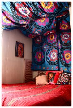 a bed with colorful bedspread and pillows on it