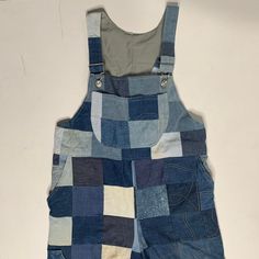 a pair of blue and white patchwork denim overalls