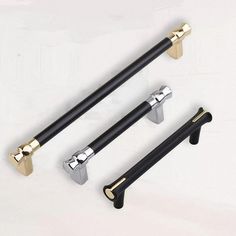 three black and gold handle handles on a white background