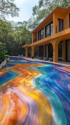 an artisticly painted pool in front of a multi - colored building