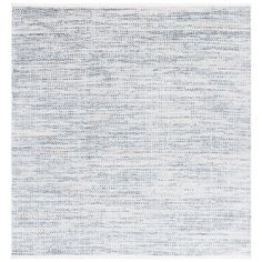 a blue and white rug with small dots on it