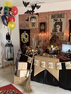 a harry potter birthday party with balloons and decorations on the wall, including a broom