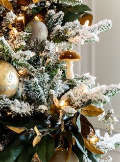 a christmas tree decorated with gold and silver ornaments