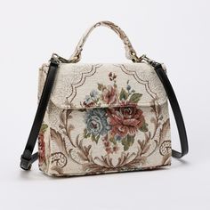 With a nod to the Victorian era, MCW's freshly combines the classic and elegant design of the traditional carpet satchel with a textural and tactile twist. This exquisite top handle satchel is a perfect blend of style and practicality. Spacious interior with zipper and slip pockets, detachable shoulder strap. Sturdy exterior in carpet or velvet, cotton lining. Convenient magnetic flap closure, brass feet for stability. Features: * Detachable, adjustable shoulder strap * Magnetic flap for easy access * Interior slip and zipper pockets * Hand-polished brass hardware * Includes dust bag Dimensions: * Satchel size: 9.50"W x 4"D x 8"H * Adjustable shoulder strap: 43.50" to 51.15" Interior Pockets: * Zipper pocket: 7"W x 5"H * Slip pocket: 8"W x 5.50"H Weight: 1lb 5oz Vintage Rectangular Flap Bag With Detachable Handle, Classic Rectangular Flap Bag With Adjustable Handle, Vintage Crossbody Satchel With Detachable Handle, Rectangular Flap Bag With Adjustable Handle For Daily Use, Vintage Satchel Flap Bag With Detachable Handle, Vintage Crossbody Bag With Detachable Handle, Beige Rectangular Flap Bag With Adjustable Handle, Vintage Crossbody Satchel With Adjustable Handle, Vintage Top Handle Shoulder Bag With Adjustable Strap