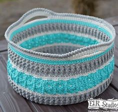 a crocheted basket sitting on top of a wooden table