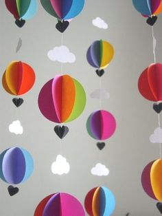 colorful hot air balloons are hanging from the ceiling