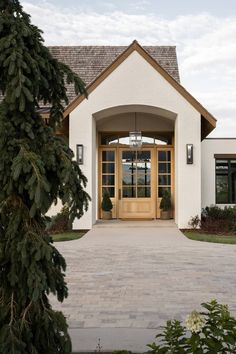 the front entrance to a home with large windows