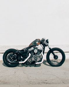 a black and brown motorcycle parked on the street