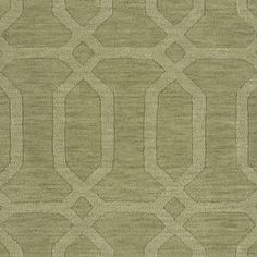 a green rug with an intricate design on the front and back side, in shades of beige