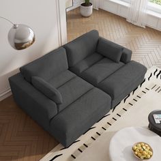 a living room with two couches and a coffee table on the floor in front of a window