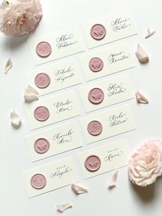 wedding place cards with pink wax seals and rose petals