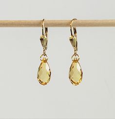 "- Striking Yellow Gold Earrings in Prestige Faceted Crystal \"Golden Topaz\" Shade 13mm Teardrop Briolettes with 14K Gold Filled Lever Backs in Seashell Detailing. See  Photos #1-3. - Stunning Earrings have many Facets to capture the light in Gold, Honey and Yellow hues. - 14K Gold Filled Jump Ring Connectors now in petite 4.5mm size. - 14K Gold Filled Lever Backs with pretty Seashell Detailing.  - See 14K Gold Filled Bali Ear Wire with petite Ball Ends Listed separately. Photos #4-5.  - 14k Go Seashell Design, Crystal Teardrop Earrings, Christmas Town, Yellow Gold Earrings, Yellow Earrings, Yellow Gold Earring, Stunning Earrings, Faceted Crystal, Earrings Collection