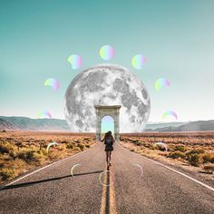 a woman is walking down the road in front of an arch with bubbles floating from it