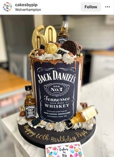 a birthday cake made to look like a bottle of whiskey and some confections