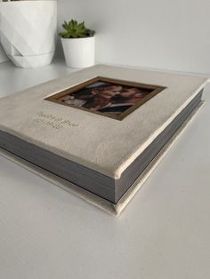 an open book sitting on top of a white table