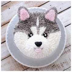 a cake decorated with a dog's face and ears