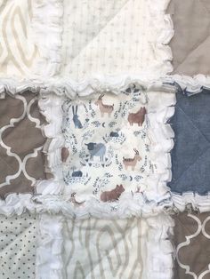 *Gorgeous handmade quilt with three cozy layers. FREE SHIPPING TO US AND CANADA, ready to ship! SAL$ priced! This quilt features Dear Stella "Into the Wild" animal print with co-ordinating patterned fabrics in taupe, denim blue and off white. Each square is quilted with a traditional "X" and seams are handclipped to create a cozy fringe.  Outside edge is double stitched for durability.  SPECS Top layer: 100% cotton quality fabrics  Middle and backing layer: cozy white flannel Measures approx. 32.5" x 42.5" (crib size) *Rag quilts make a unique keepsake/heirloom gift for baby, and this is the perfect size from birth to toddlerhood. *Please see photos for details regarding colours and layout, I do my best to provide accurate descriptions and photographs, however I do not have control over ho Baby Blanket Quilt Pattern, Nursery Gender Neutral, Neutral Baby Quilt, Quilt Baby Blanket, Patterned Fabrics, Jean Quilt, Baby Rag Quilts, Girl Cribs, Quilt Care