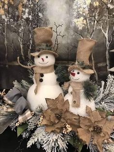 two snowmen are standing next to each other