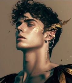 a man with gold leaves on his head and ear piercings in front of him