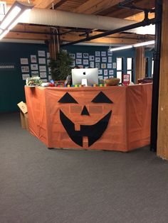 an office decorated for halloween with a pumpkin face