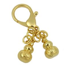 a pair of gold earrings with bells hanging from it's hooks on a white background