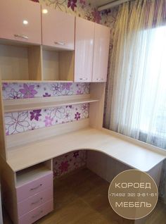 an empty desk in front of a window with floral wallpaper on the walls and floor