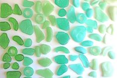 some green and white sea glass pieces on a table