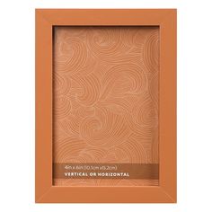 an orange frame with swirl designs on the front and bottom, for a decorative wall decoration