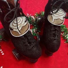 two black roller skates sitting on top of a red carpet next to christmas decorations