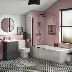 a bathroom with pink walls and black and white flooring, including a bathtub