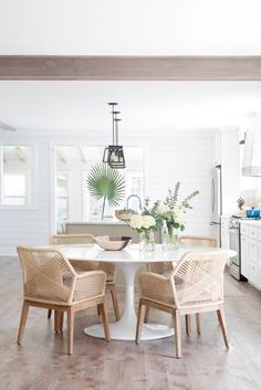 a white table with four chairs around it