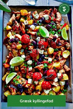 a tray filled with meat and vegetables on top of a wooden table