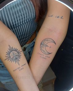 two people with matching tattoos on their arms holding each other's hands and looking at the camera