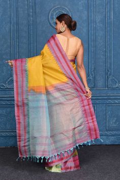 Look your best on festive occasions in this beautiful yellow striped pure Gadhwal silk saree. The saree is enhanced with bluish pink border and zari pallu. It comes with a matching blouse piece. Disclaimer: The shown stitched blouse on the model is for display purpose only. The saree comes with a matching blouse piece and finished with fall and piko. Semi-stitched Yellow Silk Pre-draped Saree, Yellow Semi-stitched Slub Silk Saree, Yellow Semi-stitched Bohemian Saree, Yellow Saree With Printed Border, Yellow Semi-stitched Saree With Printed Border, Fashion Journals, Tussar Silk Saree, Traditional Fabric, Yellow Stripes