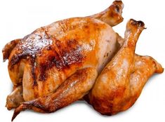 a whole chicken sitting on top of a white table next to a piece of meat