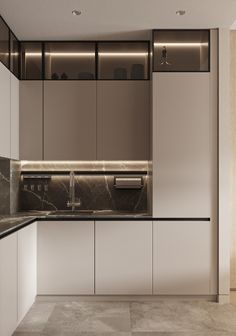 a modern kitchen with marble counter tops and white cupboards, along with stainless steel appliances