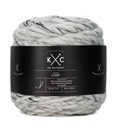 a white ball of yarn with black and white labels on the side, in front of a